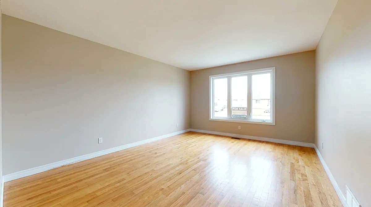 Empty vacant living room before staging, bare walls and floor