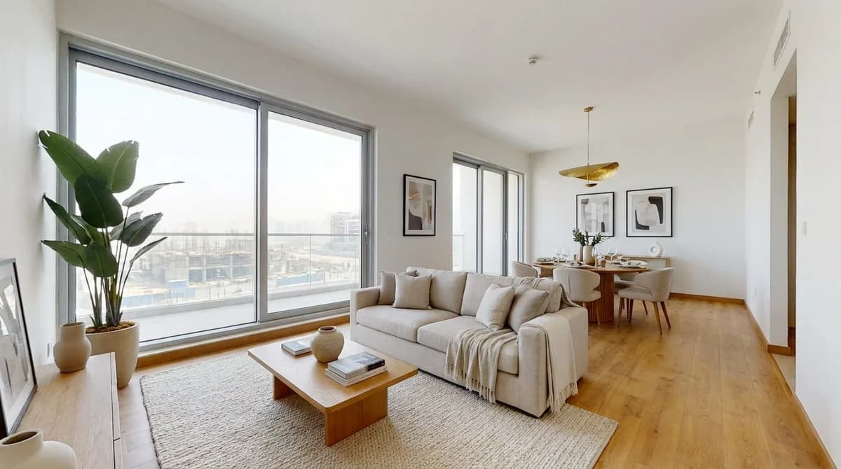 The same unbuilt unit staged as a finished show-home with sofa, dining set, rug and plants